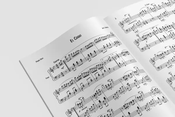 Otwarta książka z nutami "El Coqui" dla pianisty. Nuty na keyboard pokazują, jak grać utwór.